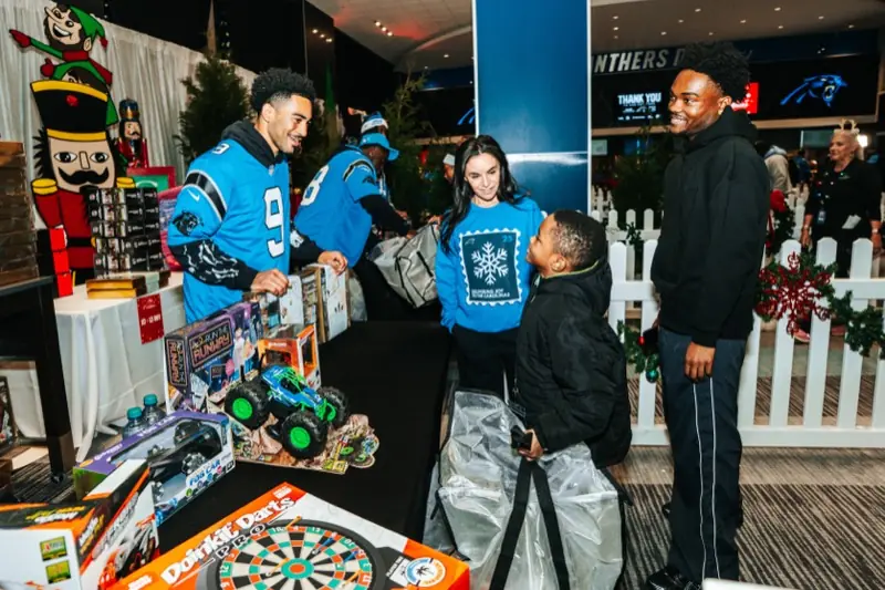 Panthers players help students choose toys